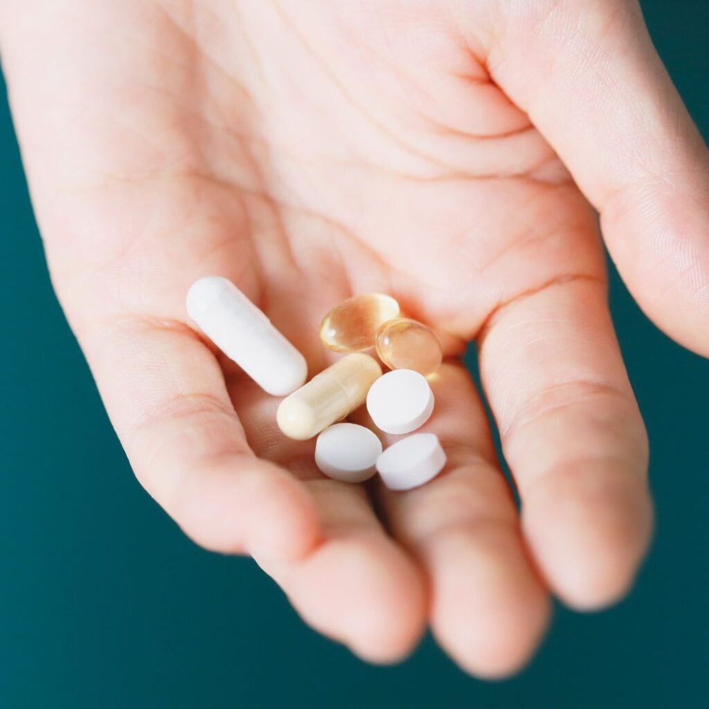 hand holding different supplements